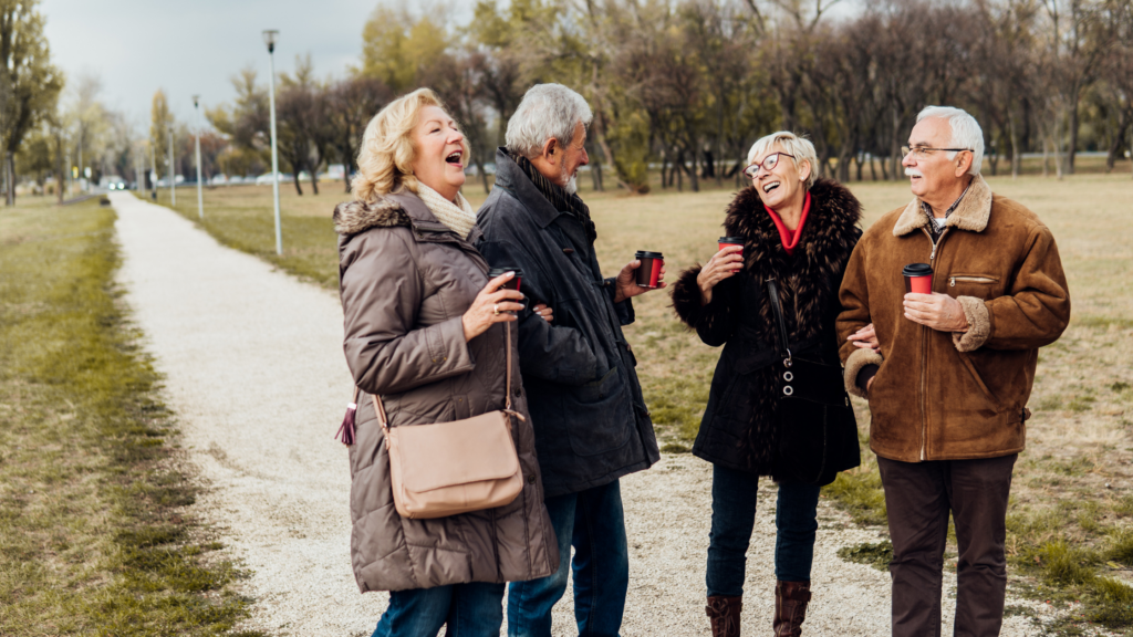 A group of older adults outdoors who are sick of online dating sites for seniors and looking for better ways to meet people over 50